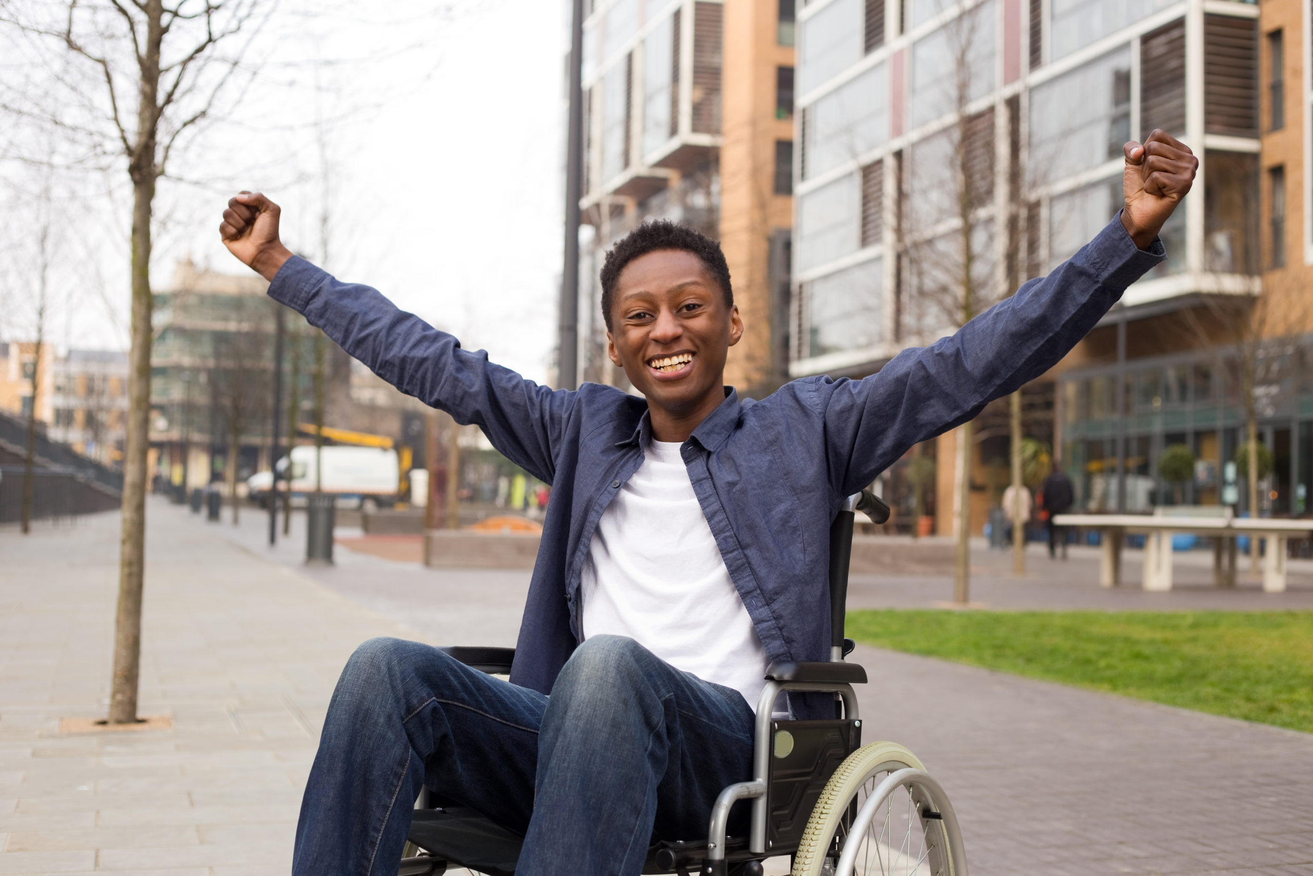 Young man in a wheelchair celebrating finding his home