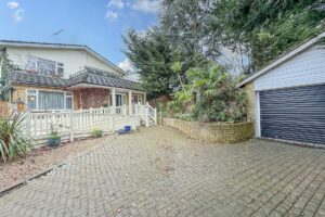 Front facade of house, with driveway and garage