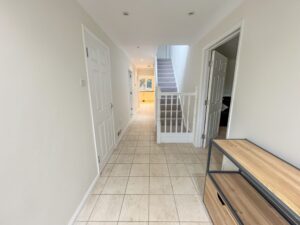 Hallway leading to kitchen and stairs